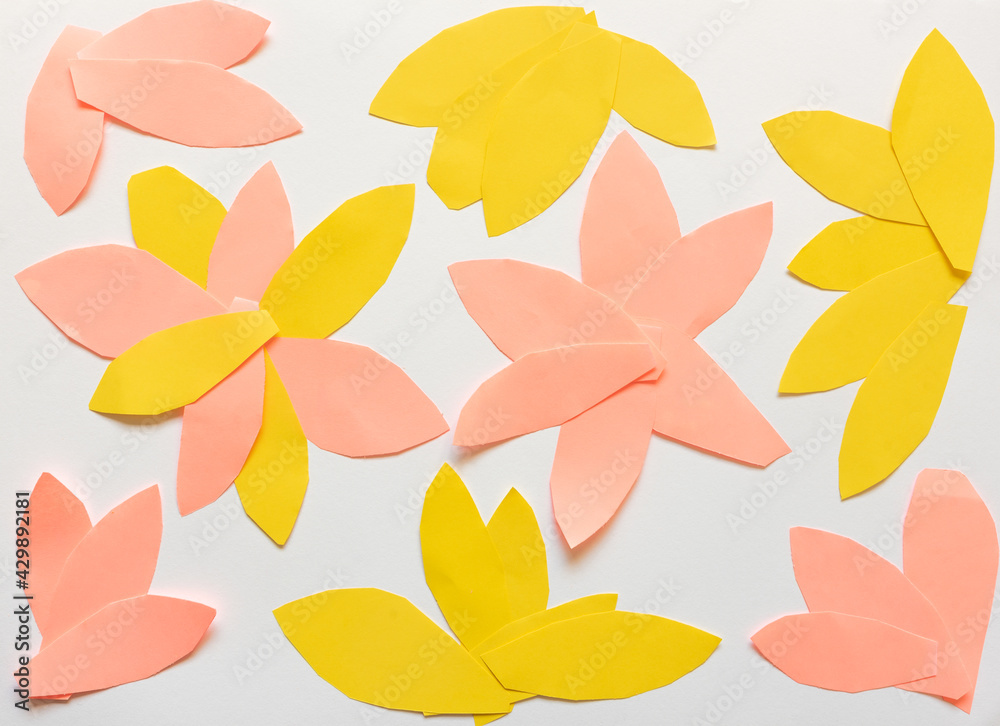 Obraz premium Abstract background concept - petal shaped coral and yellow paper arranged like flowers on white