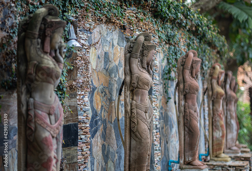 Focus of second stucco Women character(s) in literature and stone wall in background decorated place in the hotel photo