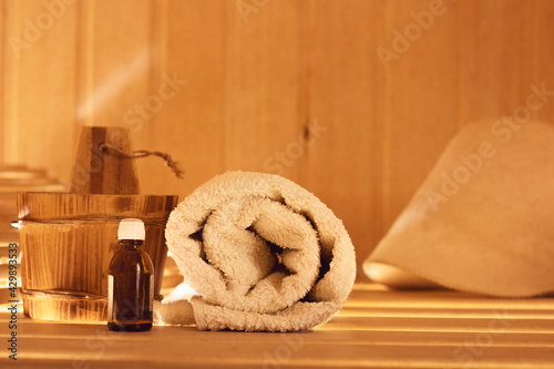 Essential oil with a towel in a roll in a bath or sauna.