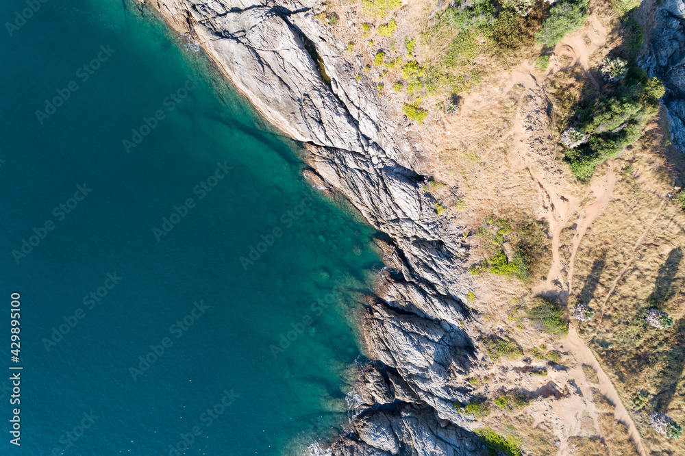High angle view Tropical sea with wave crashing on seashore and high mountain located in Phuket Thailand aerial view drone top down Amazing nature Top view Seascape