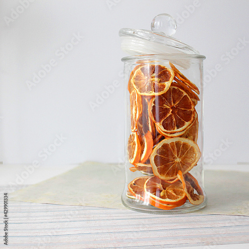 dried fruit in a jar and on the table. vegetarianism and healthy eating. energy for all time from healthy food. beautiful fruits in jars. weight loss. orange white glass. High quality photo