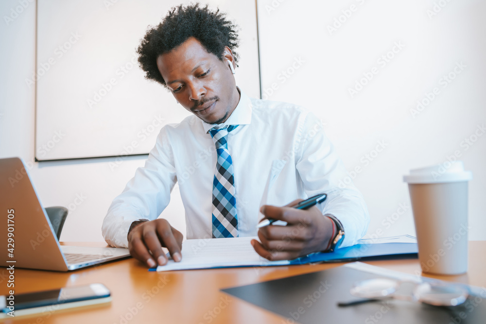 Afro American Businessman working at office. Afro American Businessman working at office.