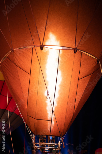 Firing in a balloon from burner,ballooning, view of the flame inside of a hot air balloon being inflated. Hot Air Balloon burners in operation,fire pumping warm air into a red balloon.