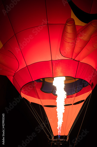 Firing in a balloon from burner,ballooning, view of the flame inside of a hot air balloon being inflated. Hot Air Balloon burners in operation,fire pumping warm air into a red balloon.