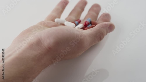 Slow motion shot of a handful of pills from an overdose