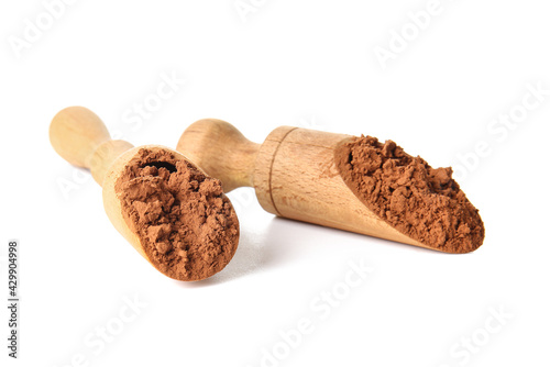 Scoops with cocoa powder on white background