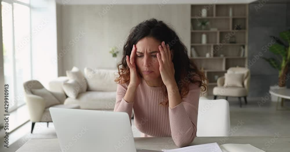 Woman sit at desk use laptop read unpleasant e-mail feels stressed. Upset female experience problems with computer, system failure, backup issue, lost important information, need device repair concept