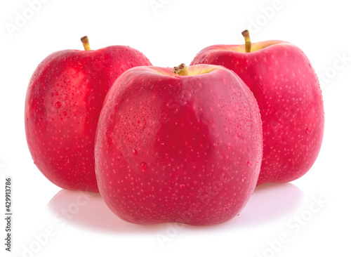 Pink lady apples with water drops isolated on white background.
