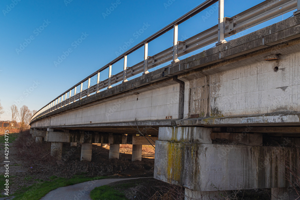 Side View of a Long Road Viaduct Built in Reinforced Concrete with Guard rail Side View of a Long Road Viaduct Built in Reinforced Concrete with Guard rail