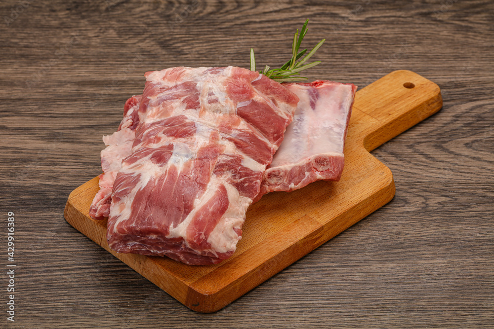 Raw pork ribs served rosemary