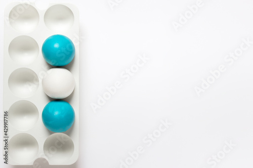Simple minimalistic Easter greeting card with three Easter eggs in vertical plastic stand hold