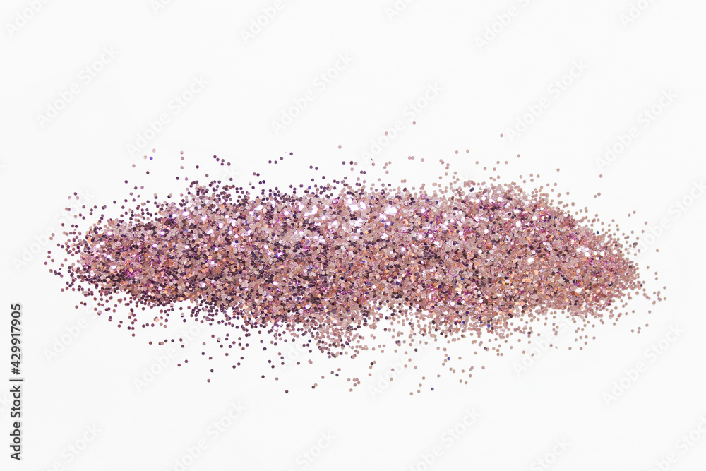Pile of pink glitter with small round particles on white background Pile of pink glitter with small round particles on white background