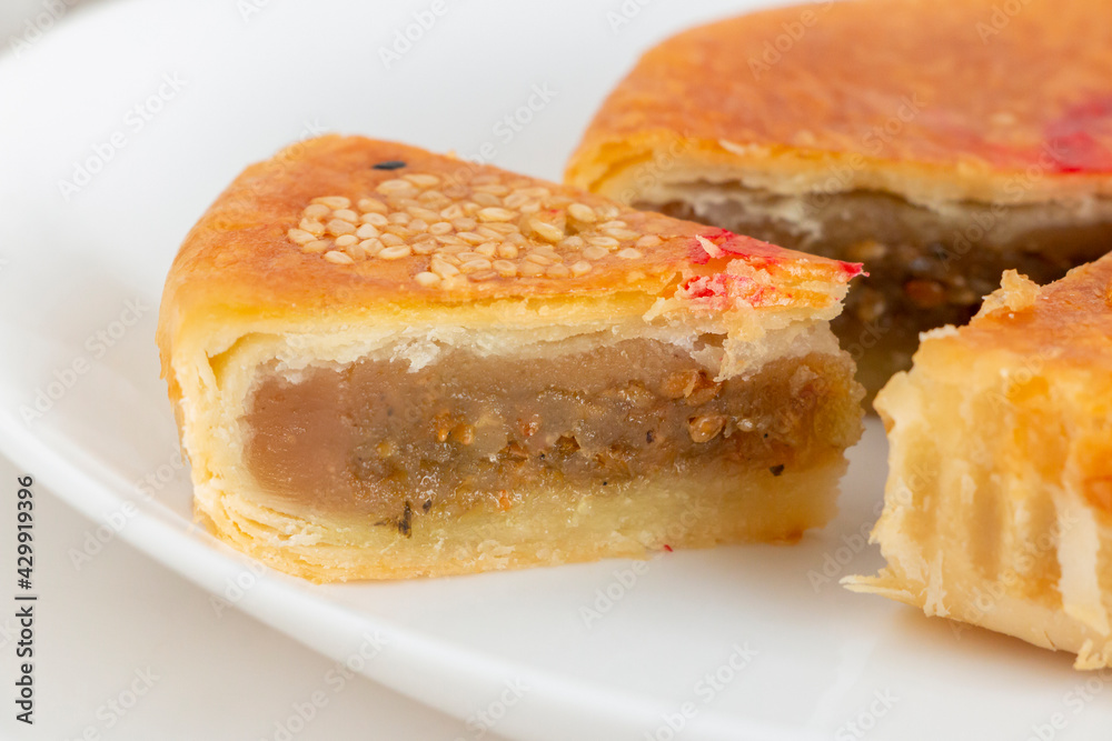 Traditional Teochew mooncake with savoury lotus paste containing preserved Chinese mustard green. Also known as 'la-pia' by Malaysian Chinese. Hand-crafted Mid-Autumn Festival pastry. Traditional Teochew mooncake with savoury lotus paste containing preserved Chinese mustard green. Also known as 'la-pia' by Malaysian Chinese. Hand-crafted Mid-Autumn Festival pastry.
