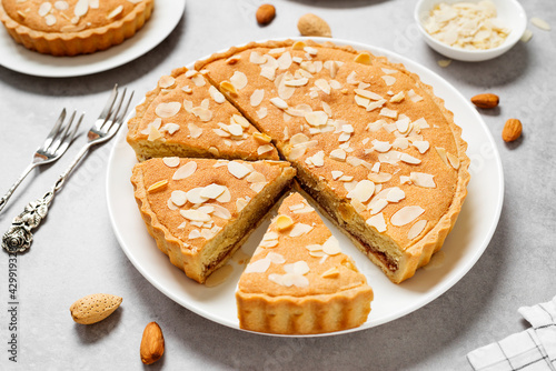 Strawberry Almond Bakewell Tart. Traditional British cuisine. Light gray background.	 photo