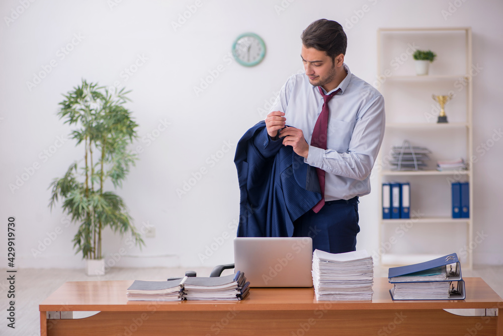 Young businessman and too much work in the office Young businessman and too much work in the office