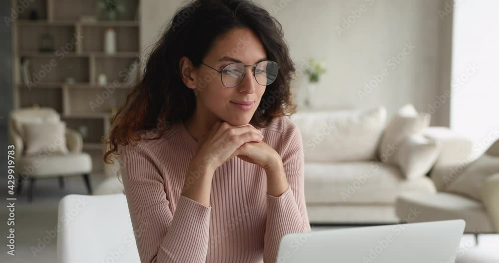 Attractive freelancer woman working from home sit at homeoffice desk in cozy light living room texting using laptop, correspond to client remotely by e-mail. Usage of modern tech for business concept