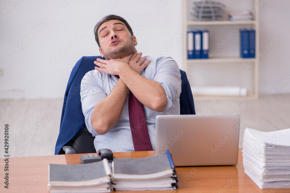 Fototapeta premium Young businessman and too much work in the office