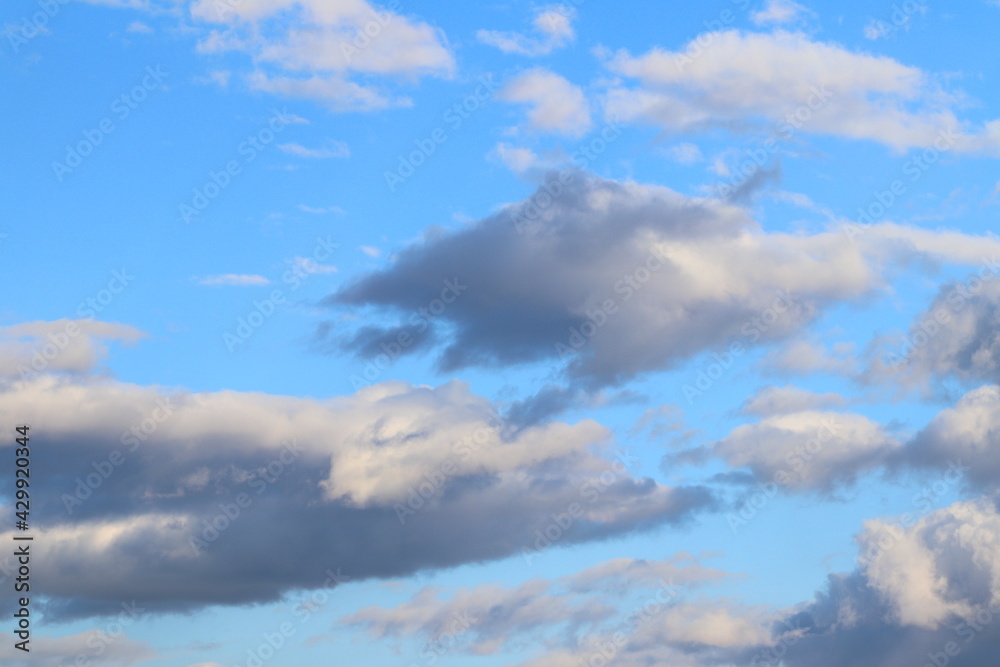 Rain gray clouds in the blue sky during the day. Rain gray clouds in the blue sky during the day.