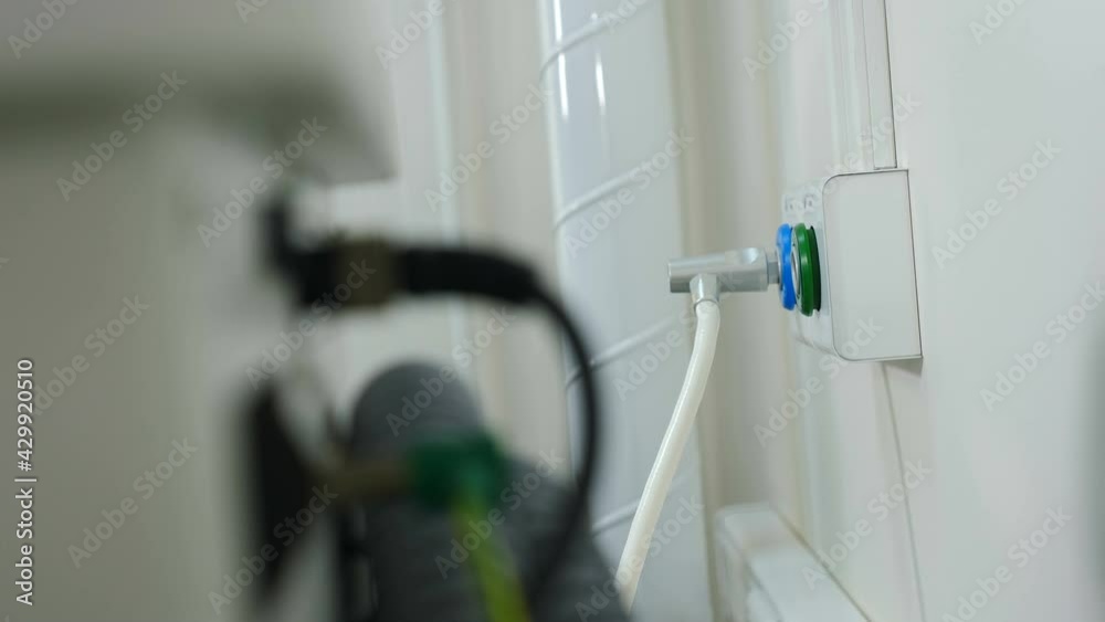 Medical worker hands plugging pipe and pipelines for oxygen, nitrous oxide into wall connectors in hospital. Equipment for life support. Oxygen for artificial lung ventilation. Healthcare. 4 k video Medical worker hands plugging pipe and pipelines for oxygen, nitrous oxide into wall connectors in hospital. Equipment for life support. Oxygen for artificial lung ventilation. Healthcare. 4 k video