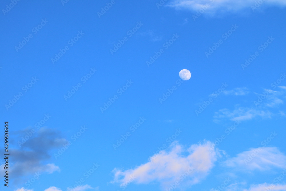 Moon in the blue sky among the clouds. Moon in the blue sky among the clouds.