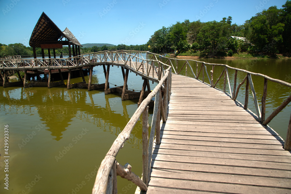 Wooden walkway bridge on the reservoir in the park Built for tourism in Thailand..