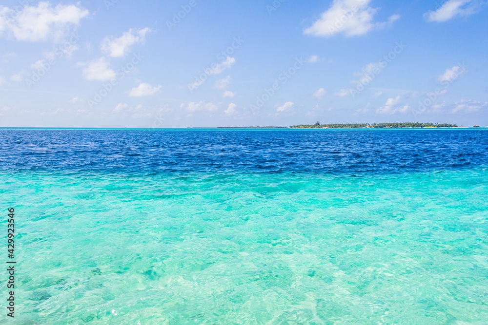 Azure water in the lagoon of the tropical island in the Maldives