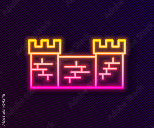 Glowing neon line Great wall of China icon isolated on black background. Vector