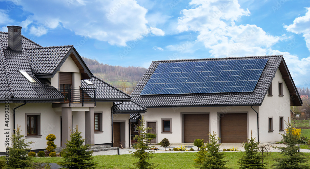 solar panels on roof of house garage renewable energy  - obrazy, fototapety, plakaty 