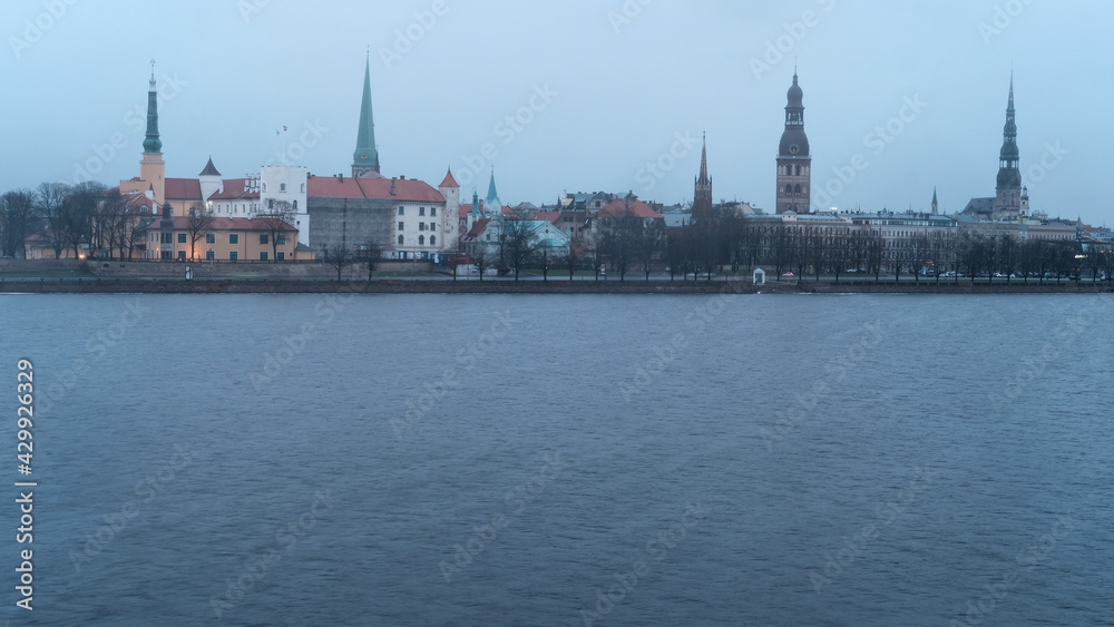Dawn over Riga, snow falls in spring