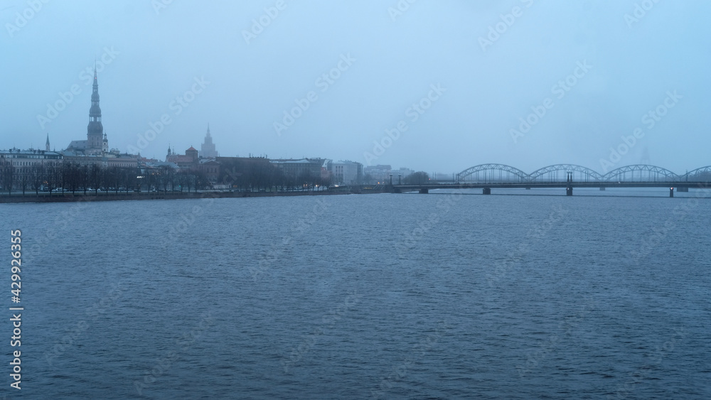 Dawn over Riga, snow falls in spring Dawn over Riga, snow falls in spring
