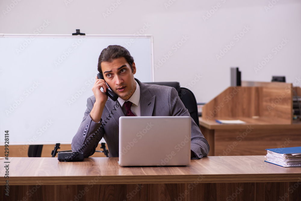 Young male business trainer in the office during pandemic Young male business trainer in the office during pandemic
