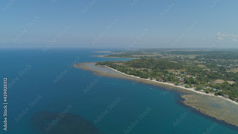 Aerial view of seashore with beaches, lagoons and coral reefs. Philippines, Luzon. Coast ocean with turquoise water. Tropical landscape in Asia.
