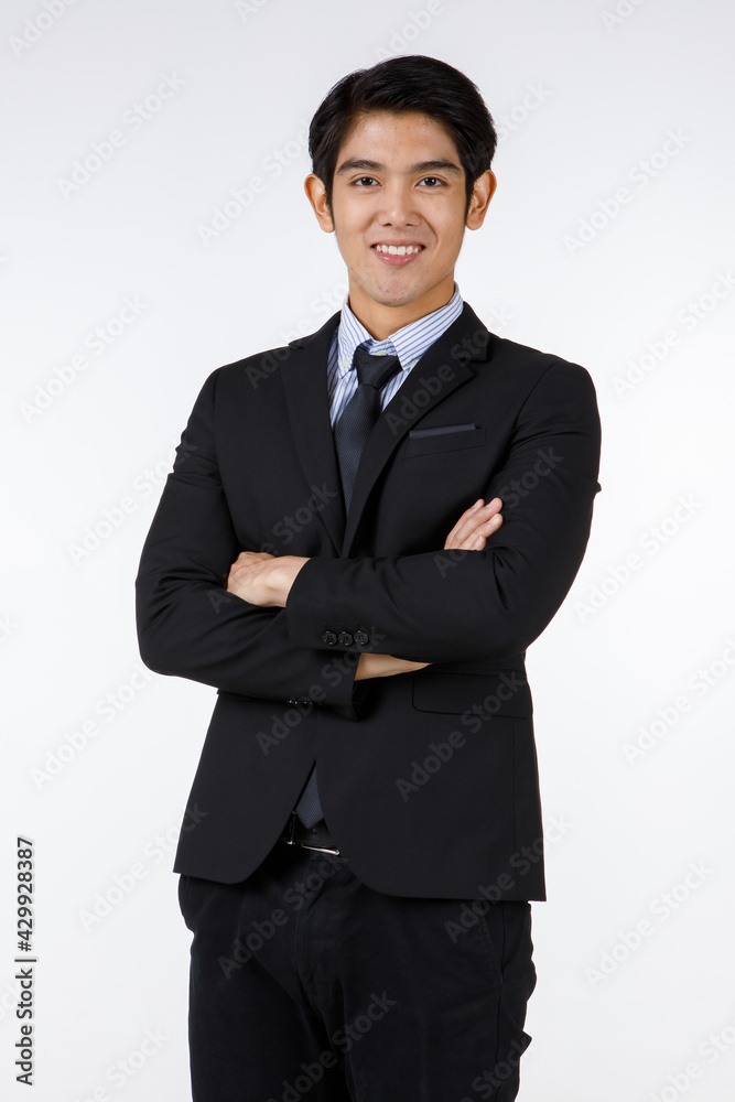 Portrait shot of Asian young black short hair happy rich ceo businessman office director in formal suit with necktie standing smiling cross arms at chest look at camera in front of white background Portrait shot of Asian young black short hair happy rich ceo businessman office director in formal suit with necktie standing smiling cross arms at chest look at camera in front of white background