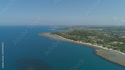 Aerial view of seashore with beaches, lagoons and coral reefs. Philippines, Luzon. Coast ocean with turquoise water. Tropical landscape in Asia. © Alex Traveler