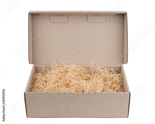 packing wood shavings chips yellow thin recycled paper box carton white background