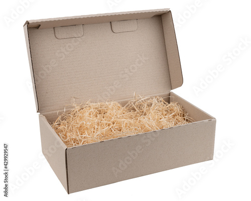 packing wood shavings chips yellow thin recycled paper box carton white background