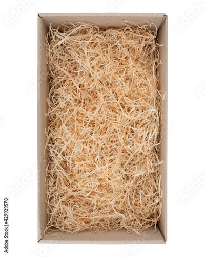 packing wood shavings chips yellow thin recycled paper box carton white background