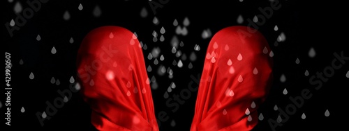 3d Illustration. Two mannequin heads with large red silk scarf, one back to the other, simulated raindrops, black background.