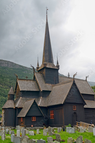 View of medieval wooden stave church at cloudy day. Lom, Norway.