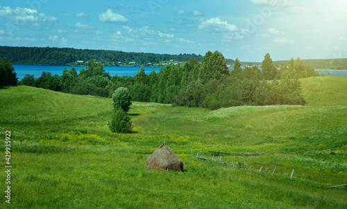 Haystacks on the summer meadow photo