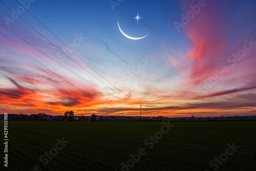 Ramadan background . Crescent moon with beautiful sunset background