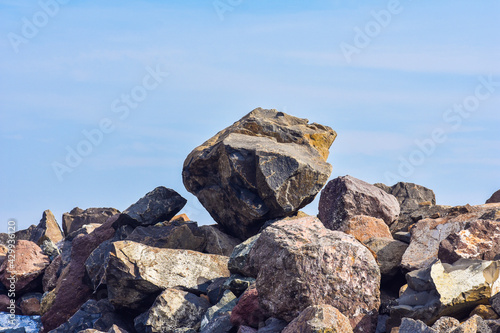 big rocks boulders pile on daylight sky background.
