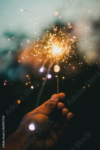hand holding sparkler photo