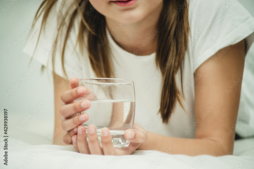 girl with a glass of water on the bed girl with a glass of water on the bed