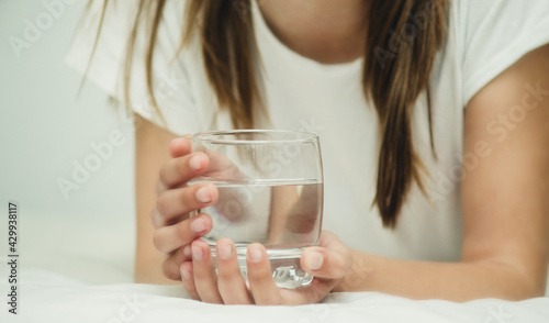 a glass of water in hands close-up