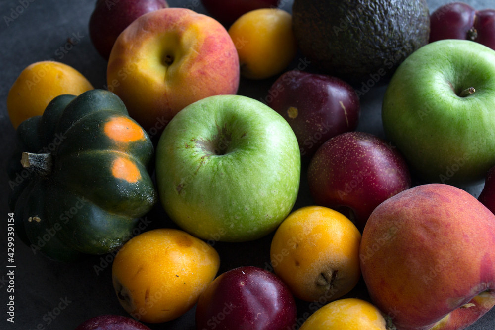 Fresh seasonal fruits and vegetables close up photo. Vibrant colors of raw ingredients. Healthy eating concept. Fresh seasonal fruits and vegetables close up photo. Vibrant colors of raw ingredients. Healthy eating concept.