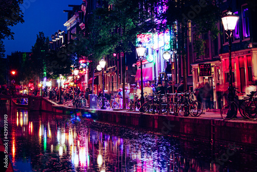 Amsterdam, The Netherlands, May 14 2018: Red lights on the canals of the Amsterdam red light district