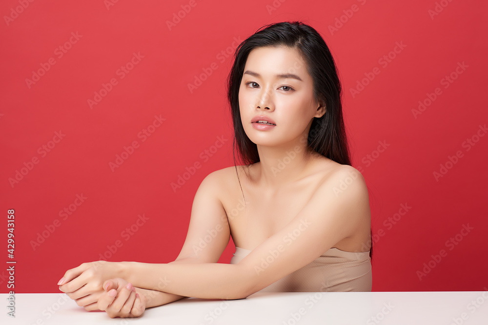 Beautiful young asian woman with clean fresh skin on red background, Face care, Facial treatment, Cosmetology, beauty and spa, Asian women portrait Beautiful young asian woman with clean fresh skin on red background, Face care, Facial treatment, Cosmetology, beauty and spa, Asian women portrait