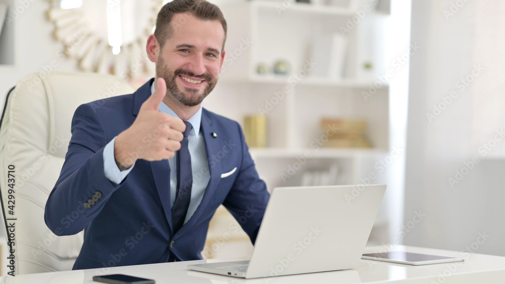 Positive Businessman with Laptop doing Thumbs Up Positive Businessman with Laptop doing Thumbs Up