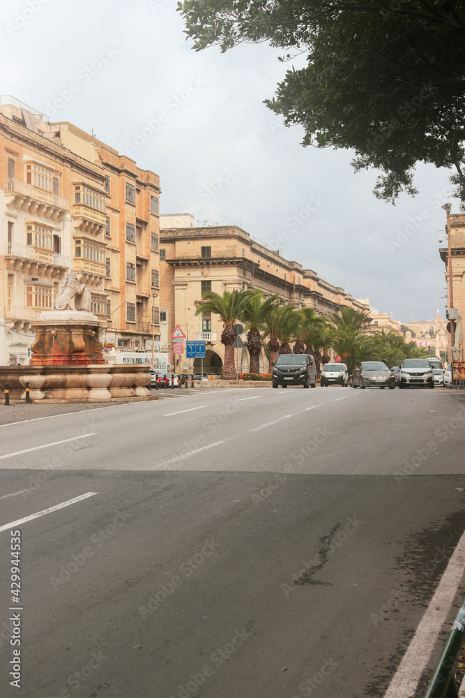 Beautiful Malta capital Valleta city street view on rainy cloudy day with raod cars